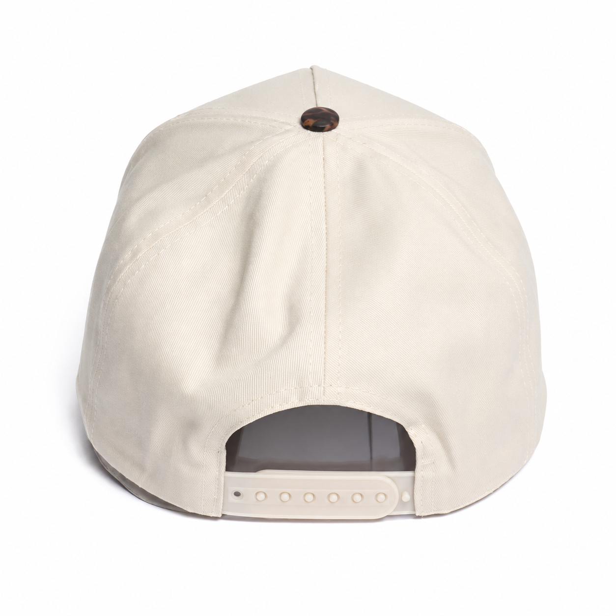 Cream snapback cap back view featuring an adjustable tonal snap closure, structured crown, and clean minimalist outdoor-inspired design.
