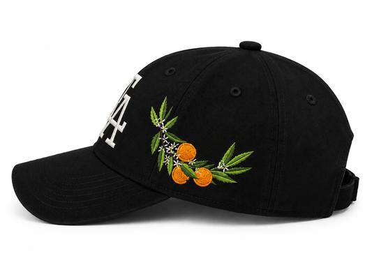 Black baseball cap side view featuring detailed citrus embroidery with oranges, green leaves, and blossoms, paired with a white “FA” logo on the front for a Florida-inspired design.