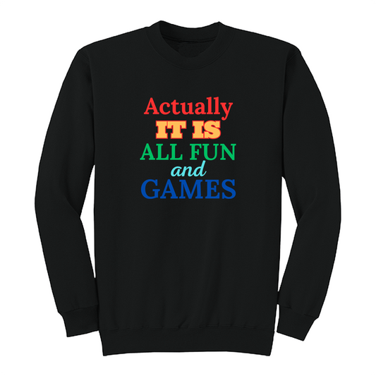Front view of a black long sleeve graphic T-shirt featuring the phrase "Actually IT IS ALL FUN and GAMES" in stacked multicolored typography. "Actually" is red, "IT IS" is gold with a red outline, "ALL FUN" is green, "and" is written in light blue script, and "GAMES" is bold blue. This playful retro-inspired graphic long sleeve shirt is perfect for casual wear, parties, game nights, and anyone with a fun sense of humor.