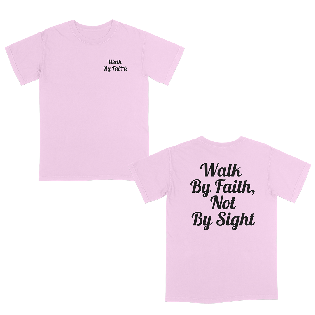 Front and back view of a light pink faith-based graphic t-shirt featuring “Walk By Faith” text on the chest and oversized “Walk By Faith, Not By Sight” typography on the back in white script lettering.