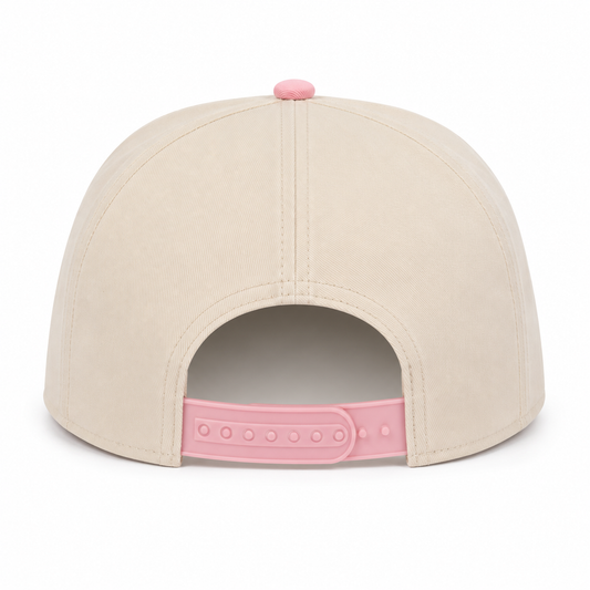 Back view of a cream snapback hat featuring a pink top button and an adjustable pink snapback closure. Displayed on a white background, showcasing the clean rear design and structured fit.
