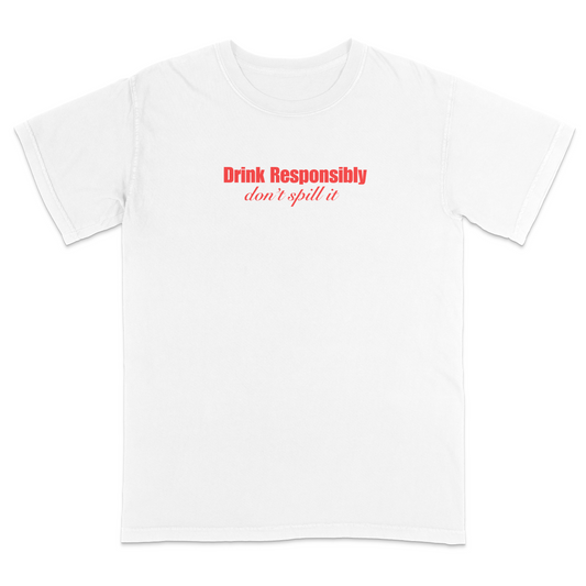 Front view of a white graphic T-shirt featuring the phrase "Drink Responsibly" in bold red lettering with "don't spill it" in elegant red script underneath. This minimalist funny drinking shirt combines clean typography with witty humor, making it perfect for parties, bar outings, casual wear, and gift giving.