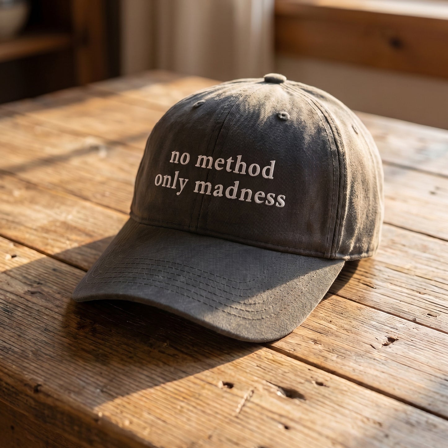 Washed black vintage-style dad hat featuring the phrase “no method only madness” embroidered in white lettering. Minimalist funny statement cap with a relaxed fit, perfect for casual streetwear, everyday outfits, and unique gift ideas.