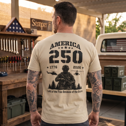 Man wearing a patriotic “America 250” graphic t-shirt featuring a military soldier, helicopters, stars, and the years 1776–2026 with the phrase “Land of the Free Because of the Brave.” Bold patriotic apparel celebrating America’s 250th anniversary, military service, freedom, veterans, and American pride.