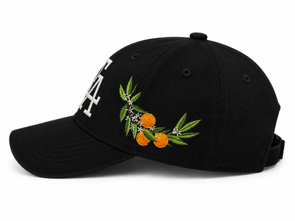 Black baseball cap side view featuring detailed citrus embroidery with oranges, green leaves, and blossoms, paired with a white “FA” logo on the front for a Florida-inspired design.