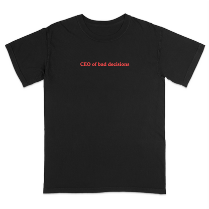 Front view of a black graphic T-shirt featuring the phrase "CEO of bad decisions" in small vintage-style red lettering centered on the chest. This minimalist humor tee offers a clean, trendy design that's perfect for casual everyday wear and sarcastic self-expression.