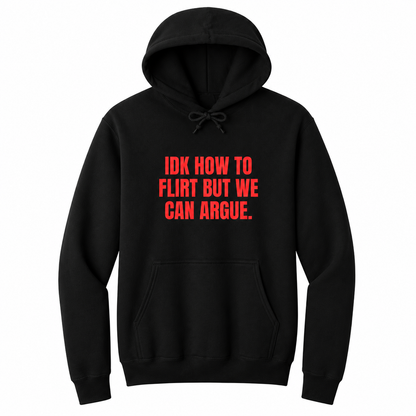 Front view of a black pullover hoodie featuring the bold red statement "IDK HOW TO FLIRT BUT WE CAN ARGUE." centered on the chest in large uppercase block lettering. The drawstrings are tied into a short bow above the design, creating a realistic product mockup. A funny sarcastic hoodie for adults with relationship humor, bold typography, and casual streetwear style.
