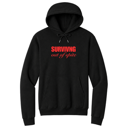 Front view of a black pullover hoodie featuring the phrase "SURVIVING" in bold red block letters above the words "out of spite" in elegant red script centered on the chest. The minimalist motivational graphic contrasts sharply against the black fabric, creating a clean, modern hoodie with a witty and resilient statement design.