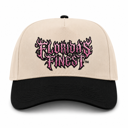 Front view of a cream and black two-tone snapback hat featuring bold embroidered "Florida's Finest™" lettering in a flame-inspired design across the front. The embroidery showcases a pink and black color scheme with stylized flame details, creating a bold and eye-catching look. The structured cap features a cream crown, black curved brim, and matching black top button, delivering a unique blend of edgy streetwear style and Florida-inspired fashion.