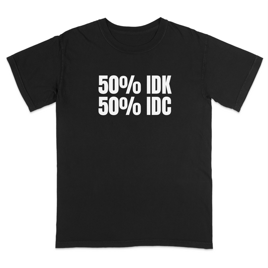 Front view of a black graphic T-shirt featuring the bold white text "50% IDK 50% IDC" centered on the chest. Displayed on a white background, highlighting the minimalist humorous design and high-contrast print.