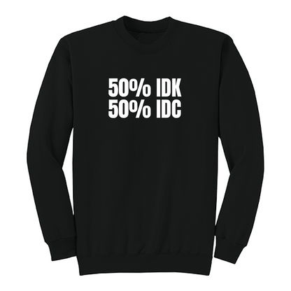 Front view of a black crewneck sweatshirt featuring the bold white phrase "50% IDK 50% IDC" printed across the chest. This minimalist funny graphic sweatshirt offers a clean, modern design with a classic fit, making it perfect for casual everyday wear or gifting to someone with a sarcastic sense of humor.