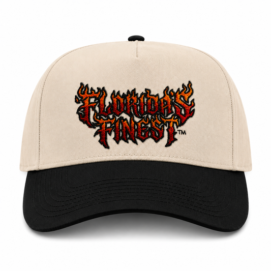 Front view of a cream and black two-tone snapback hat featuring bold embroidered "Florida's Finest™" lettering in a flame-inspired design across the front. The embroidery showcases a fiery red, orange, and black color scheme, creating a striking, edgy look. The structured cap features a cream crown, black curved brim, and matching black top button, delivering a bold statement style perfect for everyday wear and Florida-inspired streetwear.