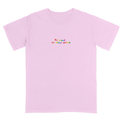 Pink t-shirt with 'be kind to your mind' text in colorful letters on a white background