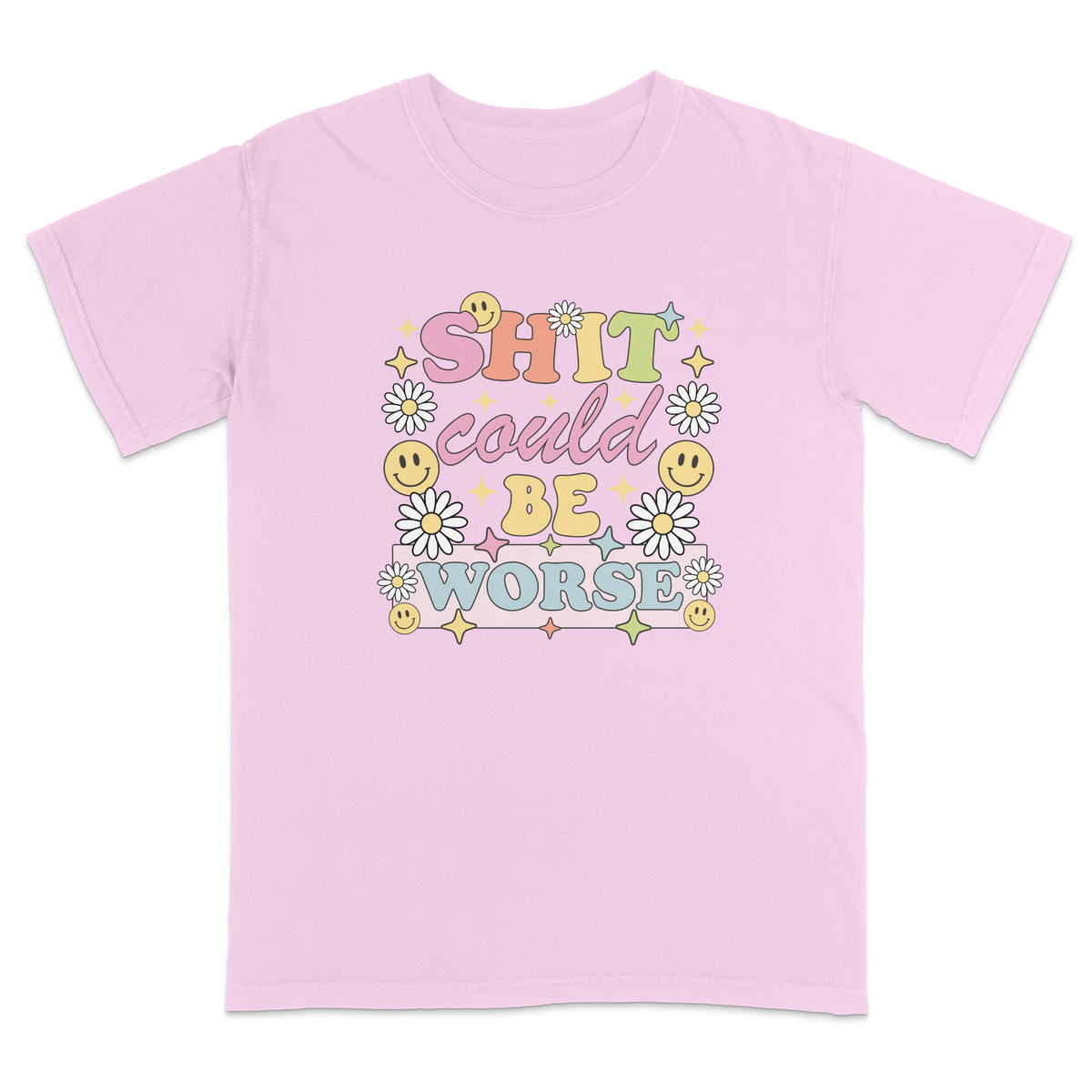 Front view of a pink graphic t-shirt featuring a retro-inspired pastel design with the phrase "SHIT could BE WORSE" in colorful vintage lettering. The design is decorated with white daisies, yellow smiley faces, and sparkling star accents, creating a playful 70s aesthetic that contrasts with the humorous sarcastic message. A funny adult graphic tee with retro floral artwork, pastel colors, and bold statement typography for casual everyday wear.