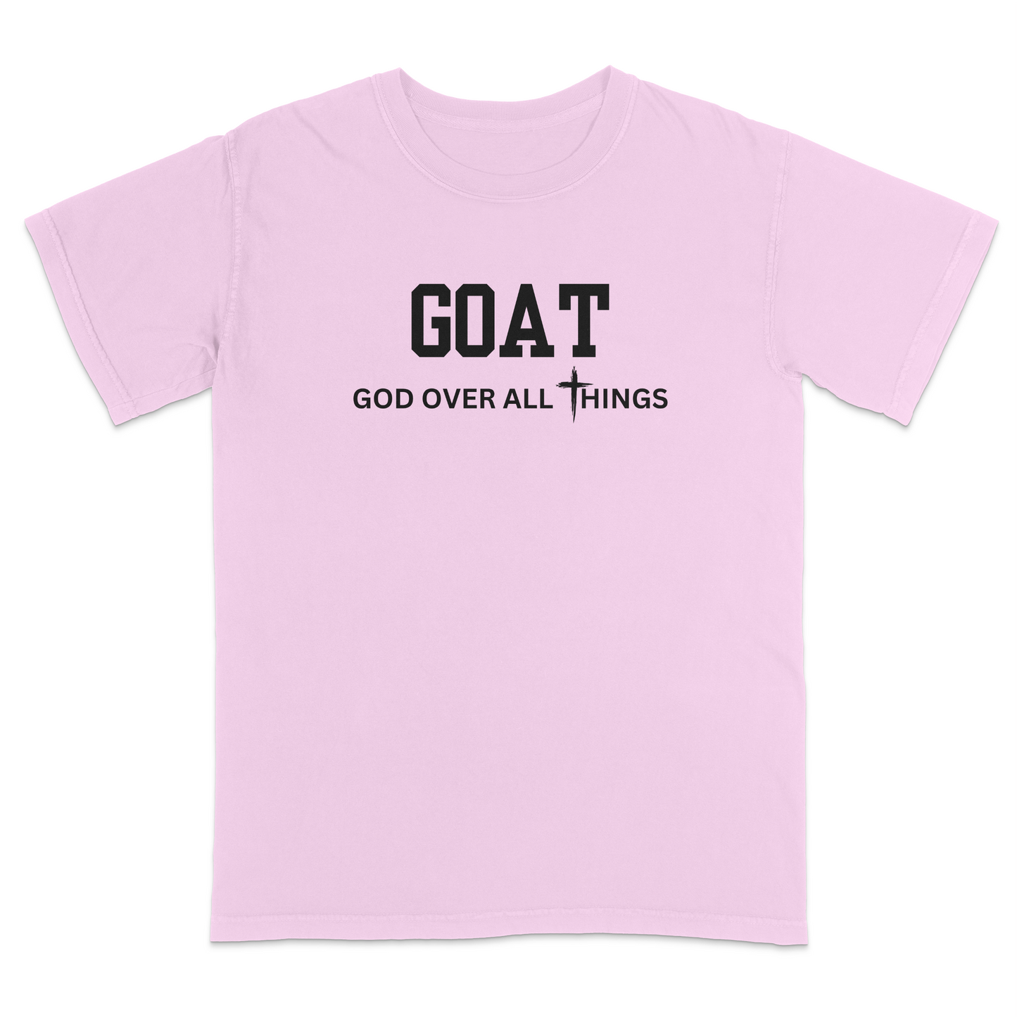 Pink faith-based Christian t-shirt featuring the bold word “GOAT” across the chest with the phrase “God Over All Things” underneath and a white cross graphic. Inspirational religious apparel designed for believers, church events, youth groups, Christian streetwear, Bible study gatherings, and everyday faith-centered fashion.