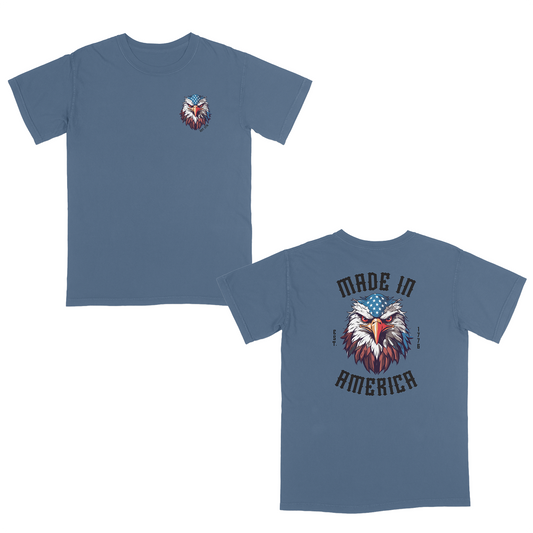 Blue jean patriotic graphic tee featuring a fierce bald eagle with an American flag bandana and bold “Made in America” gothic lettering, celebrating classic USA pride and heritage-inspired style.