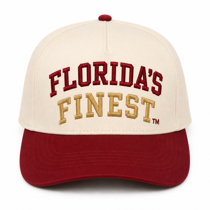 Front view of a cream and garnet two-tone snapback hat featuring bold embroidered "Florida's Finest™" lettering across the front. The design showcases burgundy embroidery for "Florida's" and gold embroidery for "Finest," inspired by classic Florida collegiate colors. The structured cap includes a cream crown, burgundy curved brim, and matching burgundy top button, delivering a timeless, vintage-inspired look perfect for game days, tailgates, and everyday Florida style.