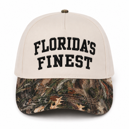 Florida’s Finest embroidered camo snapback hat featuring bold black lettering, cream crown, realistic woodland camouflage curved brim, structured fit, and outdoor-inspired Florida lifestyle design.