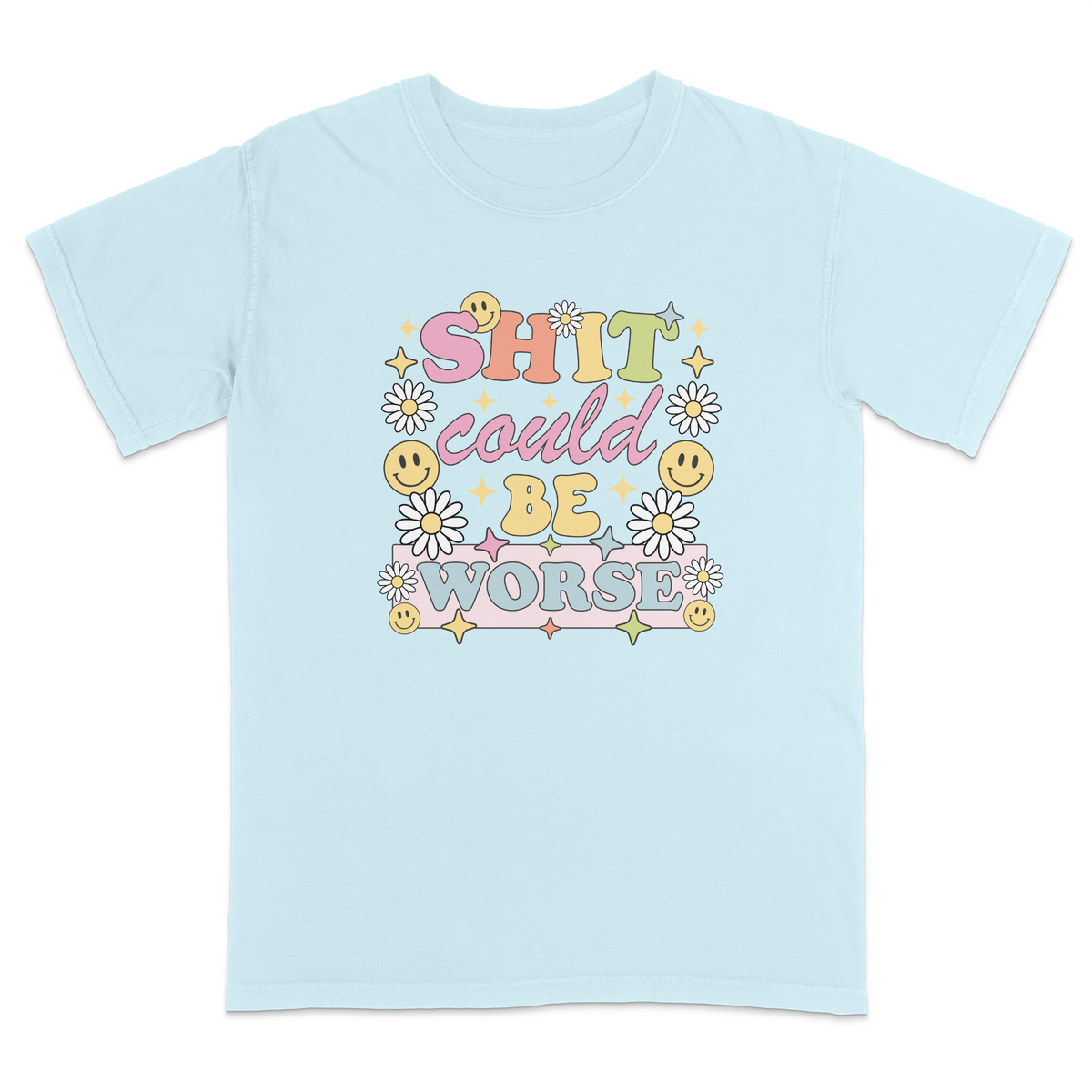 Front view of a chambray graphic t-shirt featuring a retro-inspired pastel design with the phrase "SHIT could BE WORSE" in colorful vintage lettering. The design is decorated with white daisies, yellow smiley faces, and sparkling star accents, creating a playful 70s aesthetic that contrasts with the humorous sarcastic message. A funny adult graphic tee with retro floral artwork, pastel colors, and bold statement typography for casual everyday wear.