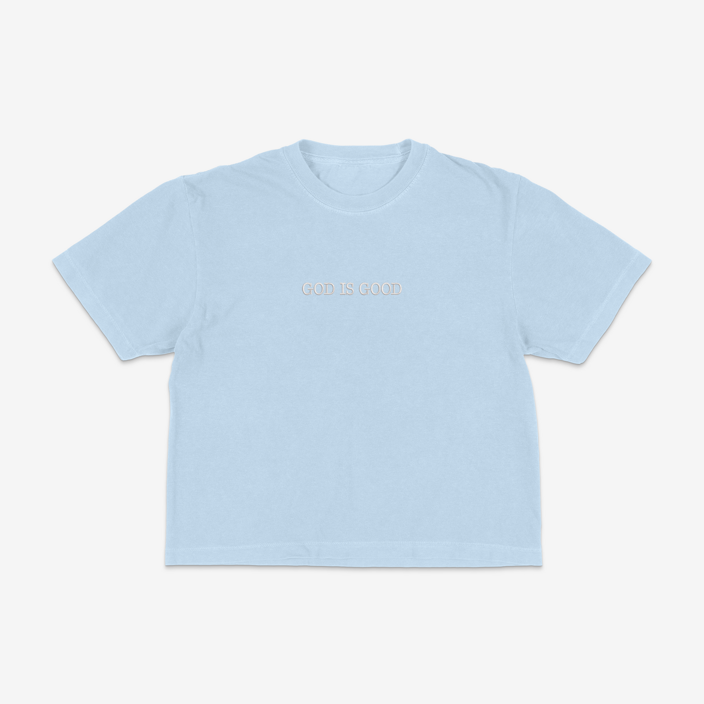 Light blue boxy tee with 'GOD IS GOOD' text on a white background