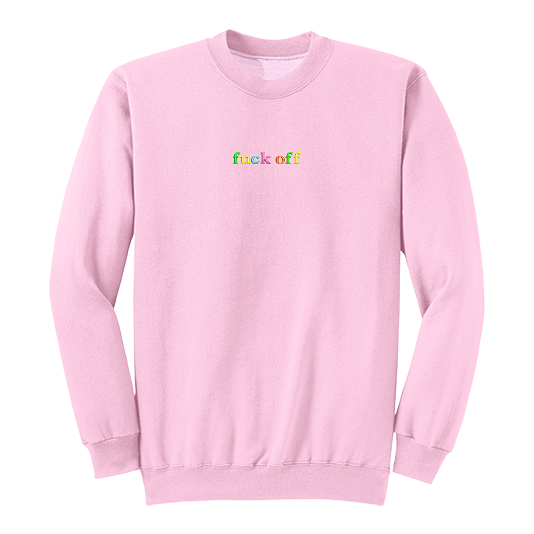 Front view of a pink long sleeve crewneck featuring the phrase "fuck off" in small lowercase letters centered across the chest. Each letter is embroidered in a different bright color, creating a subtle rainbow-inspired design with a clean, minimalist aesthetic. A bold adult long sleeve shirt with colorful typography, casual streetwear style, and sarcastic humor.