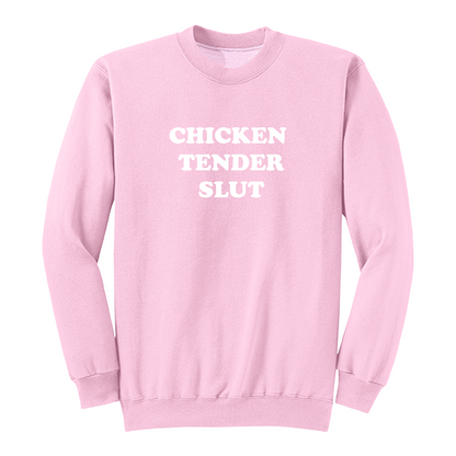 Front view of a light pink crewneck sweatshirt featuring the bold white stacked phrase "CHICKEN TENDER SLUT" in large retro bubble lettering centered on the chest. The simple vintage-inspired typography stands out against the black fabric, creating a humorous foodie-themed graphic sweatshirt with a clean, minimalist, and playful design.