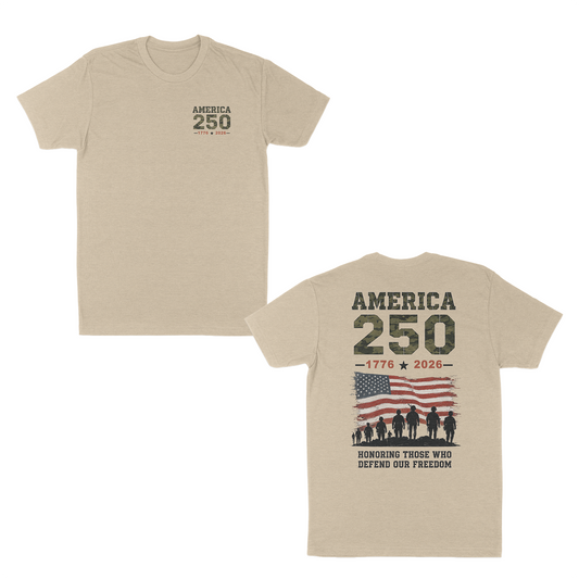 Cream patriotic America 250 t-shirt featuring a small front chest graphic and large back design with distressed American flag, military silhouettes, “1776–2026” anniversary artwork, and “Honoring Those Who Defend Our Freedom” tribute message.