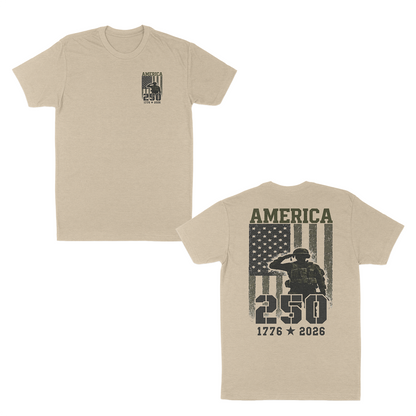 Cream patriotic military graphic t-shirt featuring a small “America 250” chest print and large back design with saluting soldier, distressed American flag, and “1776–2026” anniversary artwork.