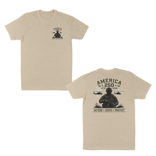 Cream patriotic military t-shirt featuring a small front chest graphic and large back print with armed soldier, helicopters, distressed American flag, “America 250” artwork, and “Defend • Serve • Protect” text.
