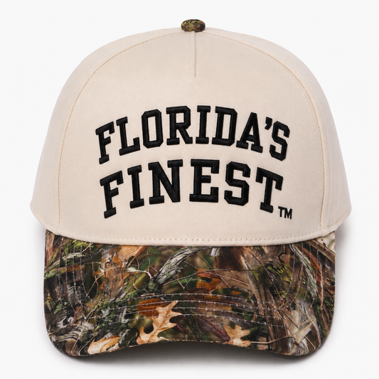 Florida’s Finest embroidered camo snapback hat featuring bold black lettering, cream crown, realistic woodland camouflage curved brim, structured fit, and outdoor-inspired Florida lifestyle design.Florida’s Finest embroidered camo snapback hat featuring bold black lettering, cream crown, realistic woodland camouflage curved brim, structured fit, and outdoor-inspired Florida lifestyle design.