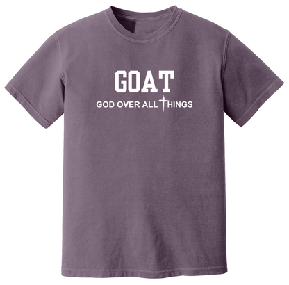 Dusk faith-based Christian t-shirt featuring the bold word “GOAT” across the chest with the phrase “God Over All Things” underneath and a white cross graphic. Inspirational religious apparel designed for believers, church events, youth groups, Christian streetwear, Bible study gatherings, and everyday faith-centered fashion.