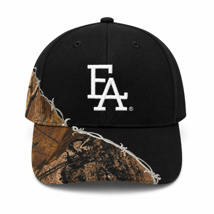 Black camo accent snapback hat featuring a bold white embroidered FLA®-style logo with barbed wire detailing across the brim and side panels for a rugged outdoor-inspired streetwear look.