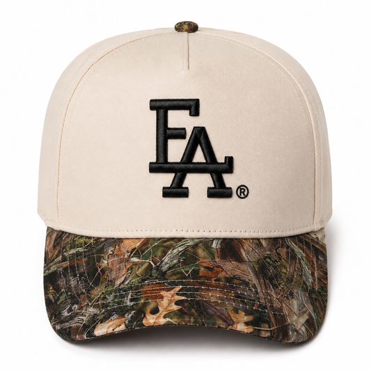 Cream and Realtree camo baseball cap featuring a bold black embroidered “FLA®” logo on the front, camouflage curved brim, and a clean outdoor-inspired two-tone design.