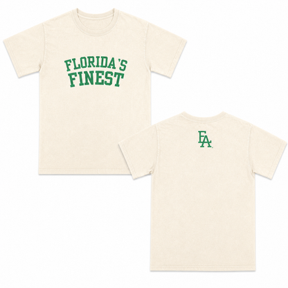 Cream short-sleeve T-shirt featuring bold Green “Florida’s Finest” text on the front and a minimalist green “FLA” logo centered on the upper back.
