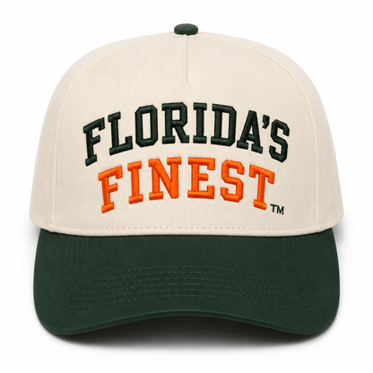 Front view of a cream and dark green two-tone snapback hat featuring bold embroidered "Florida's Finest™" lettering across the front. The design showcases dark green embroidery for "Florida's" and vibrant orange embroidery for "Finest," creating a classic Florida-inspired color combination. The structured cap includes a cream crown, dark green curved brim, and matching green top button for a timeless, everyday look perfect for Florida fans, tailgates, and casual wear.