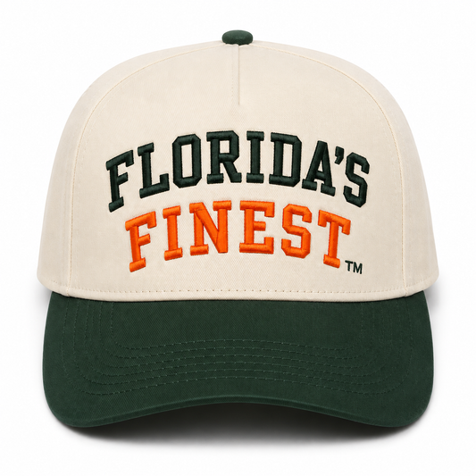 Front view of a cream and dark green two-tone snapback hat featuring bold embroidered "Florida's Finest™" lettering across the front. The design showcases dark green embroidery for "Florida's" and vibrant orange embroidery for "Finest," creating a classic Florida-inspired color combination. The structured cap includes a cream crown, dark green curved brim, and matching green top button for a timeless, everyday look perfect for Florida fans, tailgates, and casual wear.