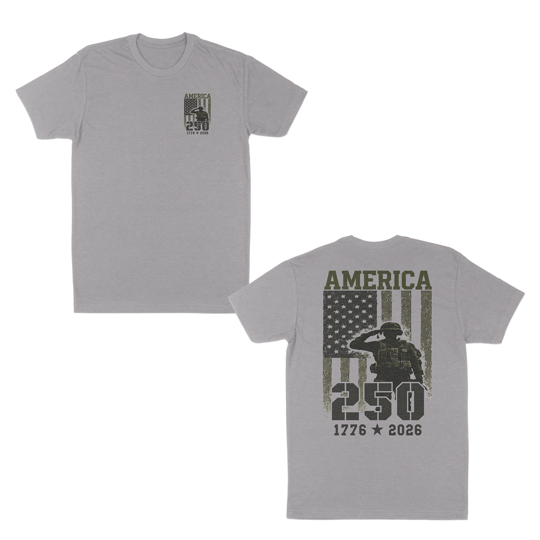 Heather grey patriotic military graphic t-shirt featuring a small “America 250” chest print and large back design with saluting soldier, distressed American flag, and “1776–2026” anniversary artwork.