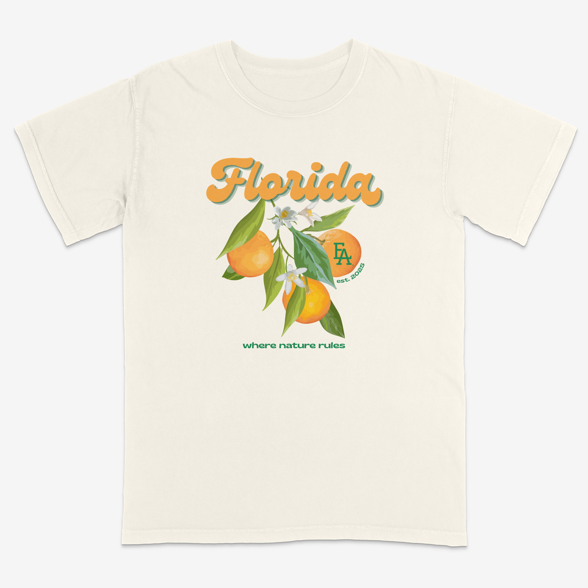 Ivory short-sleeve T-shirt featuring a colorful Florida citrus graphic with oranges, leaves, and blossoms, “Florida” script text, small “FLA est. 2025” logo, and “where nature rules” slogan on the front.
