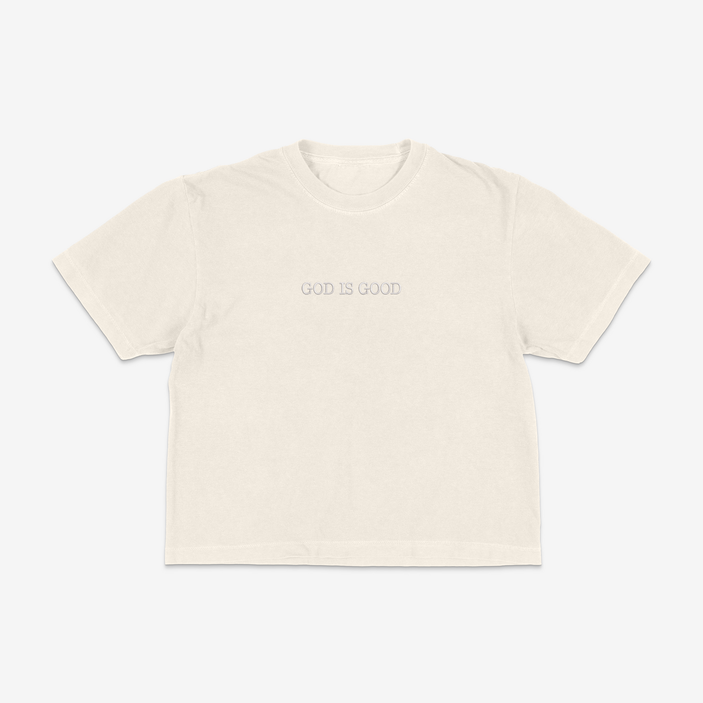 Ivory boxy tee with 'GOD IS GOOD' text on a white background