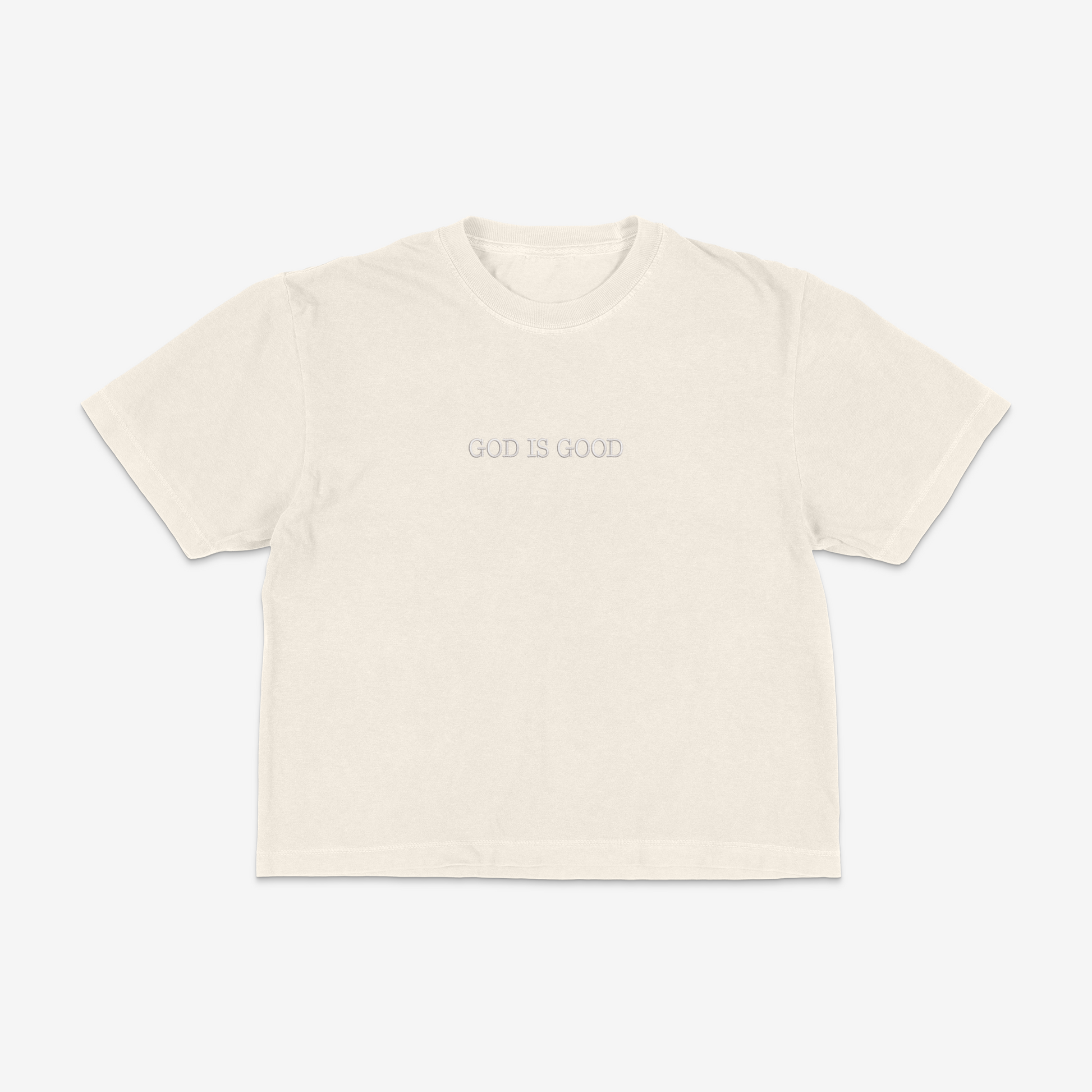 Ivory boxy tee with 'GOD IS GOOD' text on a white background