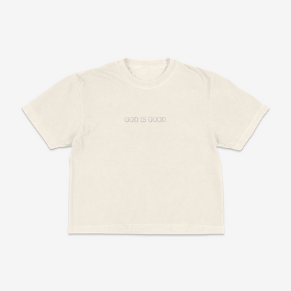 Ivory boxy tee with 'GOD IS GOOD' text on a white background