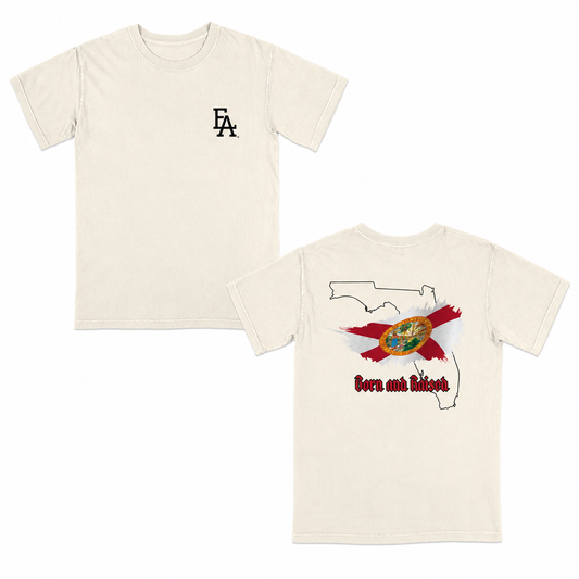 Cream short-sleeve T-shirt featuring a minimalist “FLA” logo on the front and a bold back graphic with the outline of Florida, the Florida state flag design, and “Born and Raised” text in red gothic font.