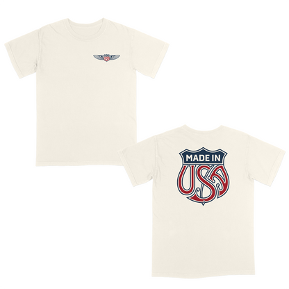 Ivory patriotic graphic t-shirt with small USA wing logo on the front and oversized “Made in USA” graphic on the back in vintage red and blue Americana style.