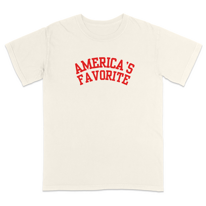 Ivory patriotic graphic tee with bold red varsity-style “America’s Favorite” lettering, featuring a clean minimalist Americana design perfect for casual Fourth of July and USA pride apparel.