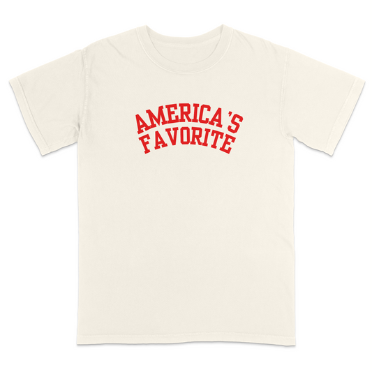 Ivory patriotic graphic tee with bold red varsity-style “America’s Favorite” lettering, featuring a clean minimalist Americana design perfect for casual Fourth of July and USA pride apparel.