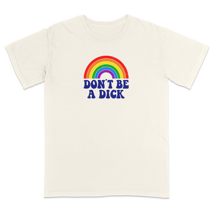 Front view of an ivory graphic T-shirt featuring a retro-style rainbow above the bold navy phrase "DON'T BE A DICK." This vintage-inspired humor tee combines colorful retro aesthetics with a funny, blunt message, making it perfect for casual everyday wear and conversation-starting style.