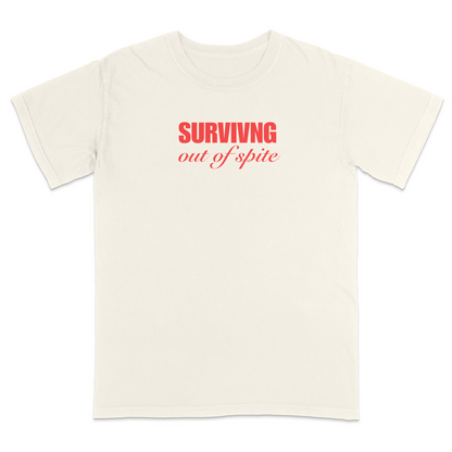 Front view of a ivory short sleeve t-shirt featuring the phrase "SURVIVING" in bold red block letters above the words "out of spite" in elegant red script centered on the chest. The minimalist red-on-black design creates a striking, resilient statement tee with a clean, modern aesthetic.