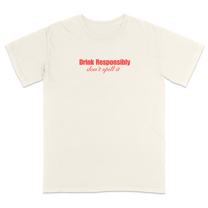 Front view of a ivory graphic T-shirt featuring the phrase "Drink Responsibly" in bold red lettering with "don't spill it" in elegant red script underneath. This minimalist funny drinking shirt combines clean typography with witty humor, making it perfect for parties, bar outings, casual wear, and gift giving.