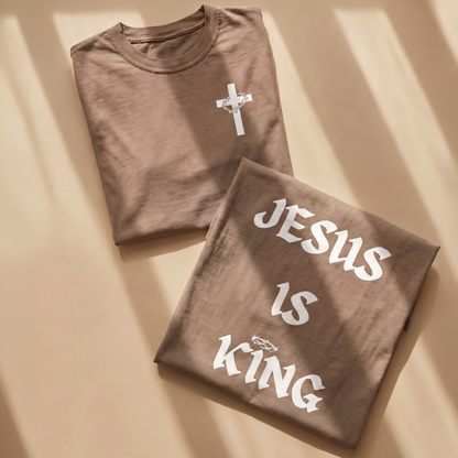 Folded brown Christian faith t-shirts featuring a white cross with crown of thorns chest graphic and bold “Jesus Is King” back design. Inspirational Christian apparel for believers, church events, worship gatherings, and everyday faith-based wear.
