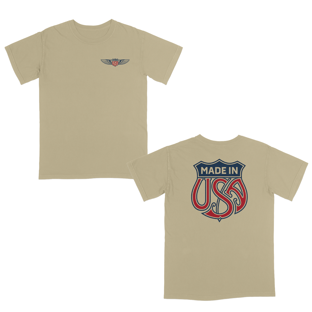 Khaki patriotic graphic t-shirt with small USA wing logo on the front and oversized “Made in USA” graphic on the back in vintage red and blue Americana style.